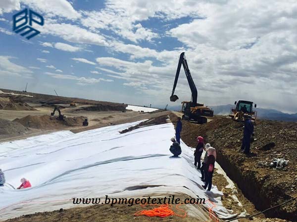 Woven textile for road construction